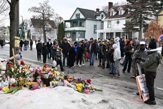 Mourners gather around a memorial for Renee Nicole Good in Minneapolis on Thursday